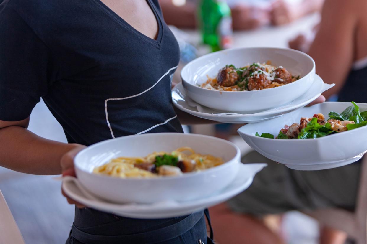 Waitress carrying plates