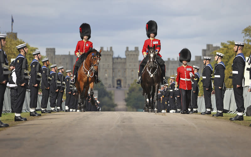 Queen Elizabeth II’s funeral procession makes its way down the Long Walk toward Windsor Castle in Windsor, England.