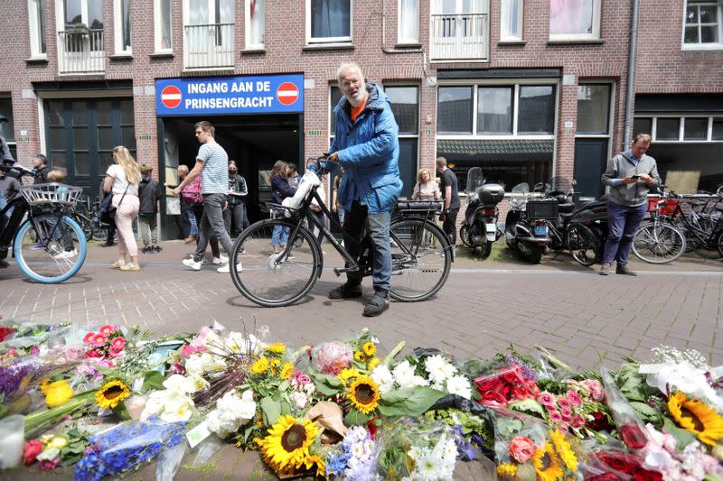 FILE PHOTO: People leave flowers where Dutch crime reporter de Vries has been shot and reported seriously injured in Amsterdam