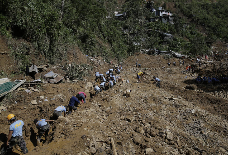 Rescuers continue to search for victims buried by a landslide after Typhoon Mangkhut lashed Itogon, Benguet province, northern Philippines on Monday, Sept. 17, 2018. Itogon Mayor Victorio Palangdan said that at the height of the typhoon's onslaught Saturday afternoon, dozens of people, mostly miners and their families, rushed into an old three-story building in the village of Ucab. The building, a former mining bunkhouse that had been transformed into a chapel, was obliterated when part of a mountain slope collapsed. (AP Photo/Aaron Favila)