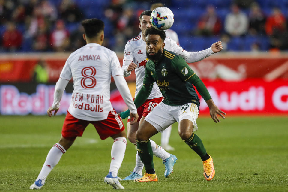 New York Red Bulls midfielder Frankie Amaya (8), left, fights for the ball against Portland Timbers midfielder Eryk Williamson (19) during the first half of an MLS soccer match, Saturday, May 7, 2022, in Harrison, N.J. (AP Photo/Eduardo Munoz Alvarez)