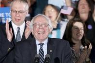 Democratic U.S. presidential candidate Bernie Sanders smiles after winning at his 2016 New Hampshire presidential primary night rally in Concord, New Hampshire February 9, 2016. REUTERS/Rick Wilking