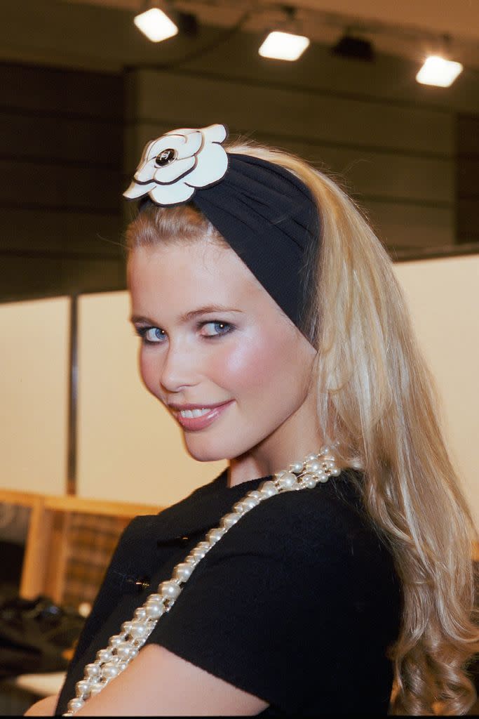 Claudia schiffer in pearls and a black headband 