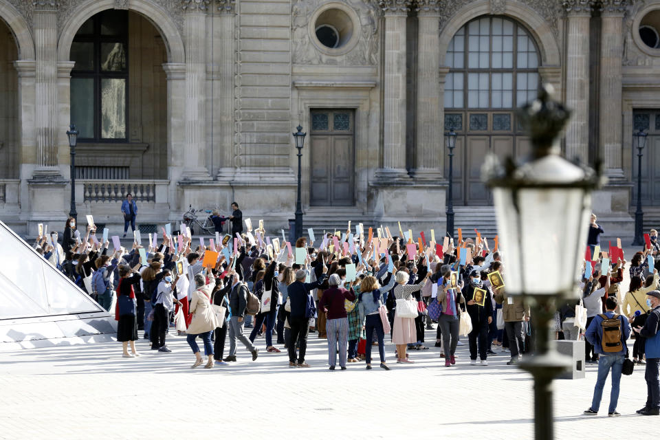 Guide speakers demonstrate to warn about their financial situation in front of the Louvre Museum, in Paris, Monday, July 6, 2020. The home of the world's most famous portrait, the Louvre Museum in Paris, reopened Monday after a four-month coronavirus lockdown. (AP Photo/ Thibault Camus)