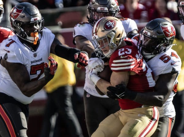 San Francisco 49ers running back Christian McCaffrey (23) is grabbed by Tampa Bay Buccaneers linebacker Lavonte David (54) on Sunday at Levi's Stadium in Santa Clara. Calif. Photo by Terry Schmitt/UPI