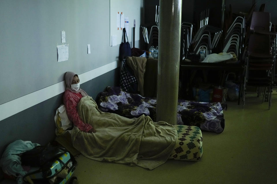 A woman on hunger strike rests as she occupies with others a space of the VUB Dutch-speaking university in Brussels, Tuesday, June 29, 2021. More than two hundreds of migrants without official papers and who have been occupying a church and two buildings of two Brussels universities since last February, began a hunger strike on 23 May to draw the attention of Brussels authorities to their plight. (AP Photo/Francisco Seco)