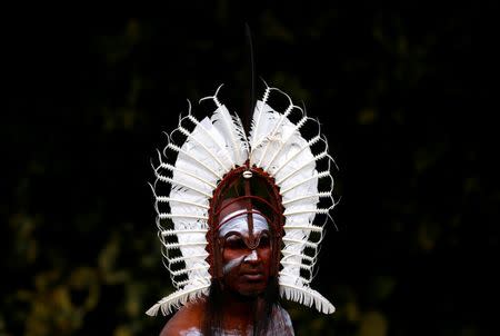 An indigenous man from the Torres Strait Islands wears a traditional dress as he performs during a welcoming ceremony at Government House in Sydney, Australia, June 28, 2017. REUTERS/David Gray