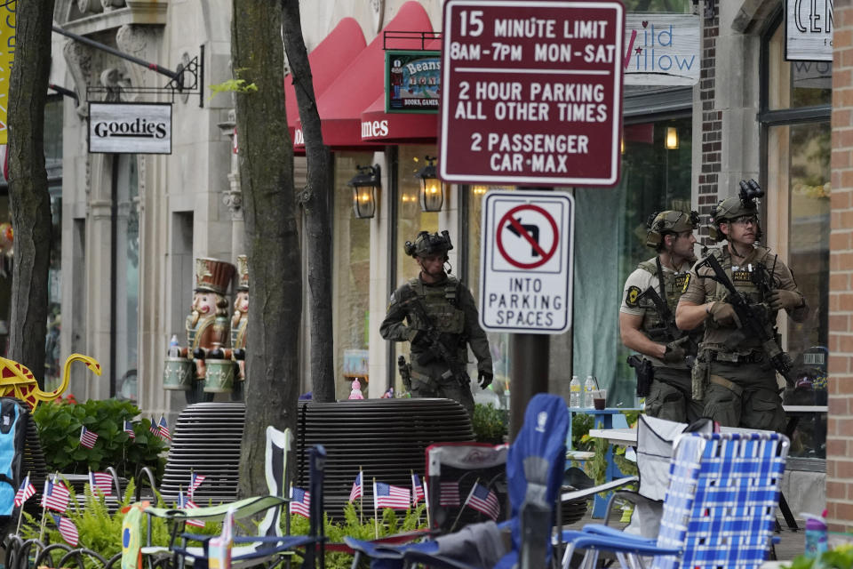 Law enforcement search after a mass shooting at the Highland Park Fourth of July parade in downtown Highland Park, Ill., a Chicago suburb on Monday, July 4, 2022. (AP Photo/Nam Y. Huh)