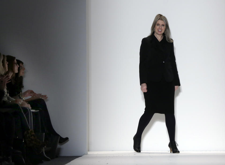 Designer Jenny Packham acknowledges audience applause after her Fall 2013 collection was modeled, during Fashion Week in New York, Tuesday, Feb. 12, 2013. (AP Photo/Richard Drew)