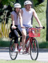 <p>Peter Weber and Kelley Flanagan hop on a tandem bike on Tuesday while hunkered down together in Los Angeles. </p>