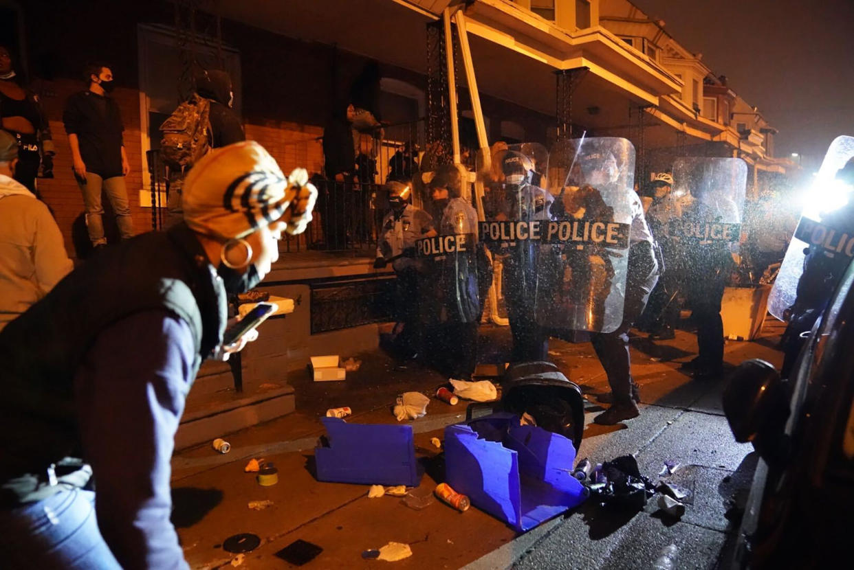 Police officers move in formation during a protest in response to the police shooting of Walter Wallace Jr., Monday, Oct. 26, 2020, in Philadelphia