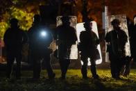 Police in riot gear line up Friday, Oct. 9, 2020, during protests in Wauwatosa, Wis. On Wednesday, District Attorney John Chisholm declined to charge Wauwatosa police Officer Joseph Mensah in the February fatal shooting of 17-year-old Alvin Cole outside a mall. (AP Photo/Morry Gash)