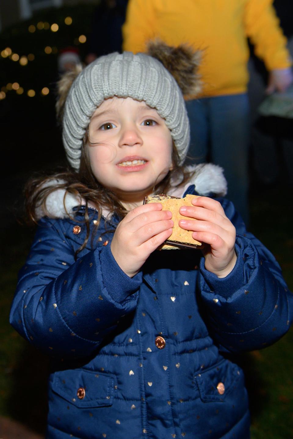 The Lakeville Lions Club held their third annual Christmas tree lighting event on Saturday, Dec. 4 at the club's Main Street headquarters. Three-year-old Adalyn enjoys the s’more she prepared.