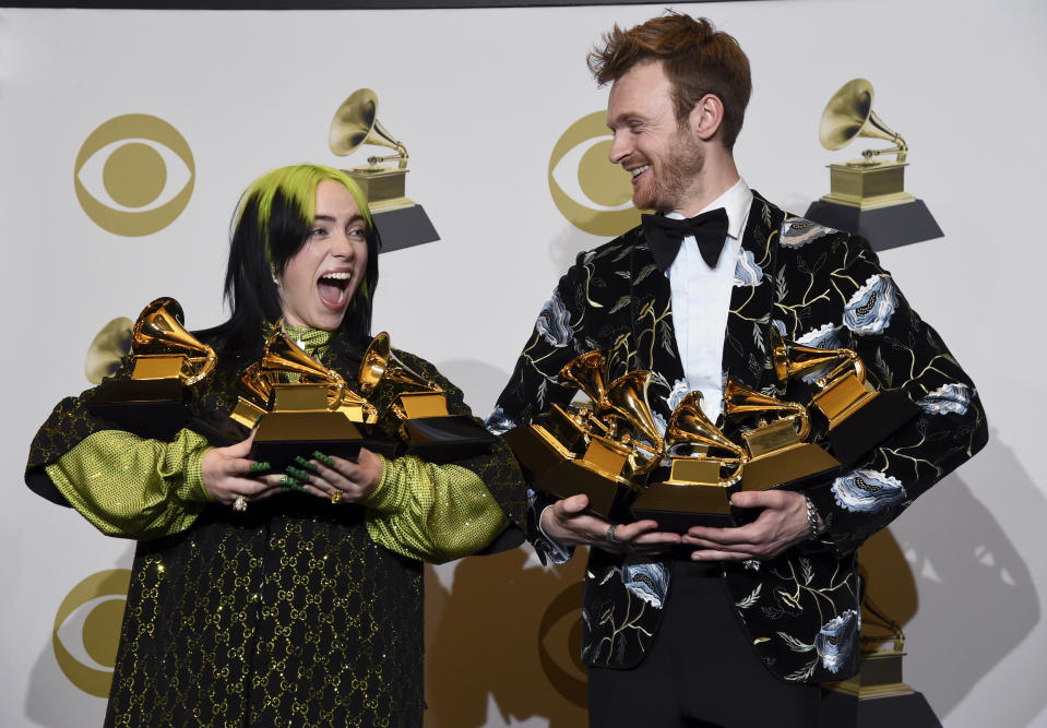 Billie Eilish, left, and Finneas O'Connell pose in the press room with the awards for best album, best engineered album and best pop vocal album for "We All Fall Asleep, Where Do We Go?," best song and record for "Bad Guy," best new artist and best producer, non-classical at the 62nd annual Grammy Awards at the Staples Center on Sunday, Jan. 26, 2020, in Los Angeles. (AP Photo/Chris Pizzello)