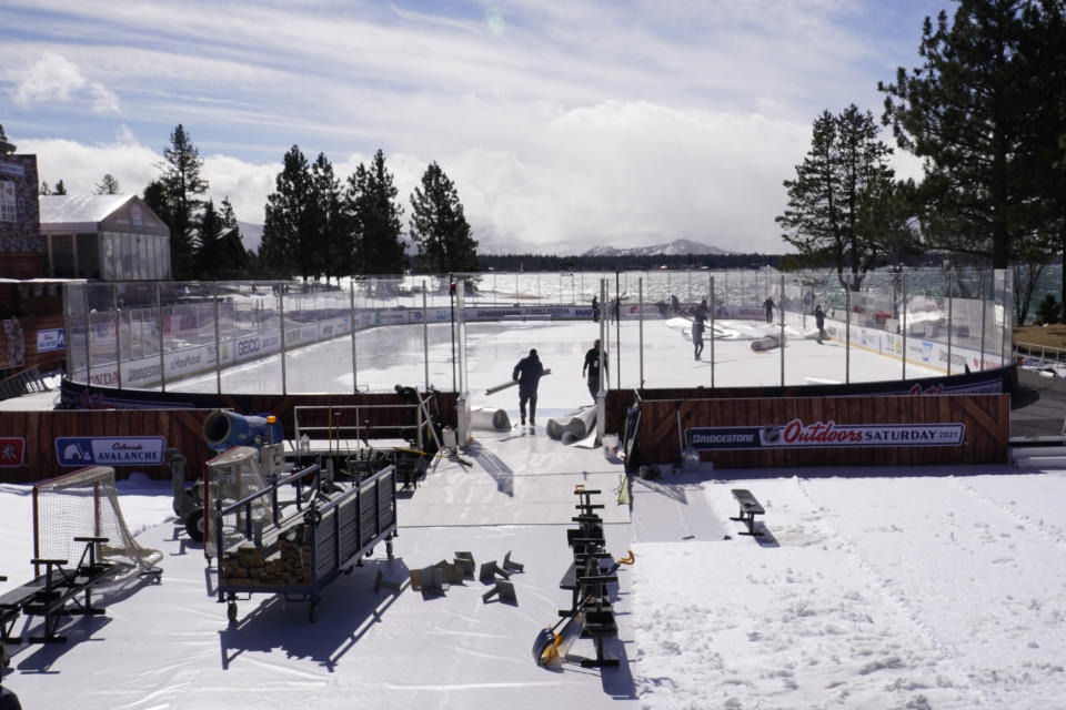 Workers put the finishing touches on the temporary ice rink, Friday, Feb. 19, 2021, built at the Edgewood Tahoe Resort, that will host two NHL games, this weekend at Stateline, Nev. The Colorado Avalanche will play the Vegas Golden Knights Saturday and the Philadelphia Flyers will face off against the Boston Bruins Sunday. (AP Photo/Rich Pedroncelli)