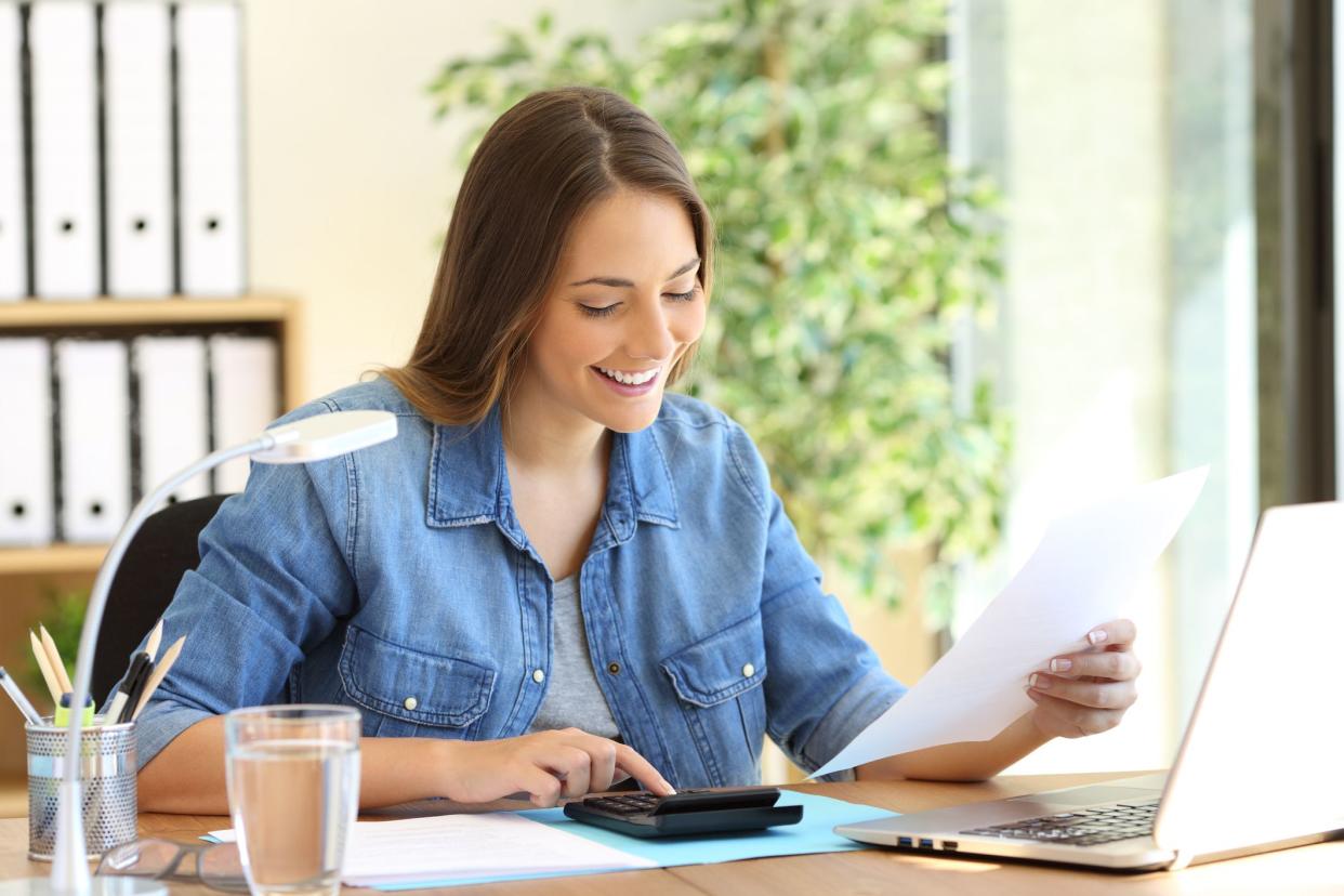 Freelance woman calculating a budget in a desktop at office