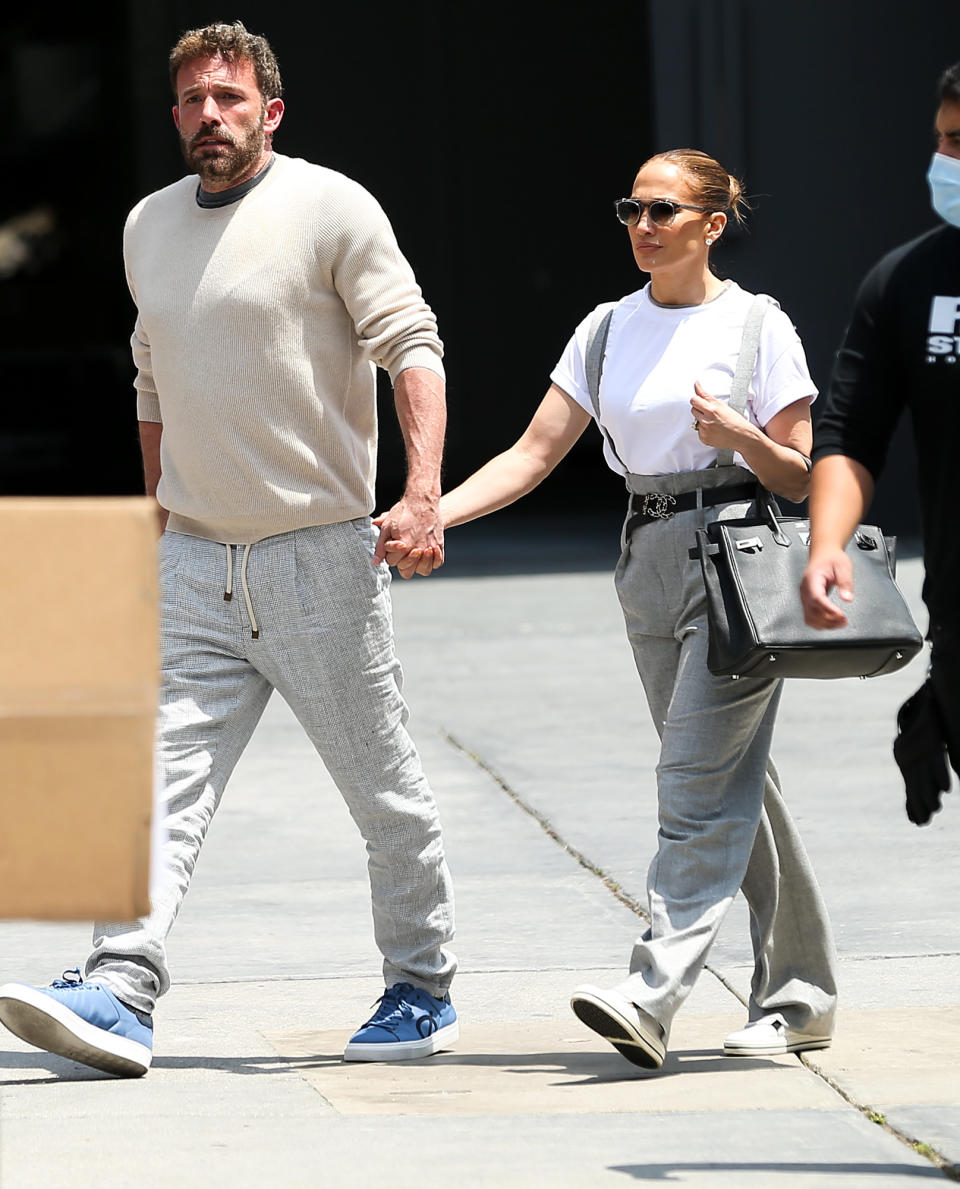 <p>Jennifer Lopez and Ben Affleck make their way to Red Studios in Hollywood on May 3.</p>