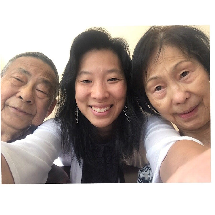 Betty Lin-Fisher, center, with her parents. [Family photo]