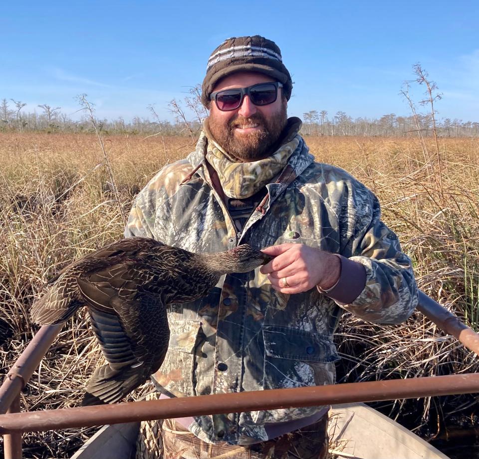 Columnist Ian Nance with a black duck in North Carolina's Outer Banks.