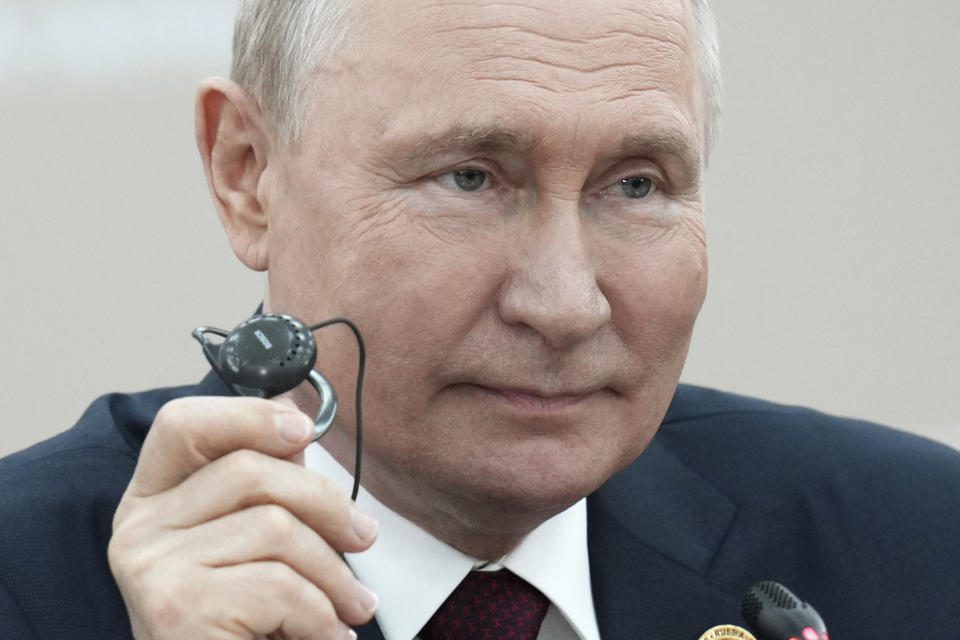 Russian President Vladimir Putin holds an earphone as he attends a meeting with Burundian President Evariste Ndayishimiye on the sideline of the Russia-Africa Summit in St. Petersburg, Russia, Thursday, July 27, 2023. (Alexei Danichev, Sputnik, Kremlin Pool Photo via AP)