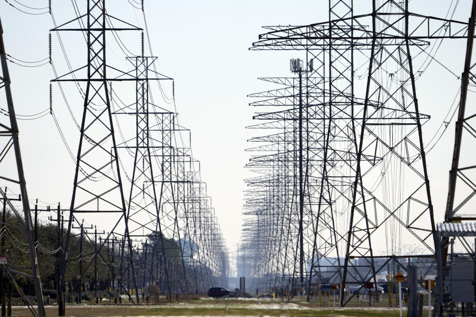 FILE - This Tuesday, Feb. 16, 2021 file photo shows power lines in Houston. On Friday, Feb. 19, 2021, The Associated Press reported on stories circulating online incorrectly asserting wind turbines freezing over in the cold weather were primarily responsible for Texans losing heat and electricity this week. Failures in natural gas, coal and nuclear energy systems were responsible for nearly twice as many outages as frozen wind turbines and solar panels combined, the Electric Reliability Council of Texas, which operates the state's power grid, said in a press conference Tuesday. (AP Photo/David J. Phillip)