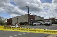Investigators work at the site of a fatal shooting in downtown Dadeville, Ala., on Sunday, April 16, 2023. Several were killed during a shooting at a birthday party Saturday night, the Alabama Law Enforcement Agency said. (AP Photo/Jeff Amy)