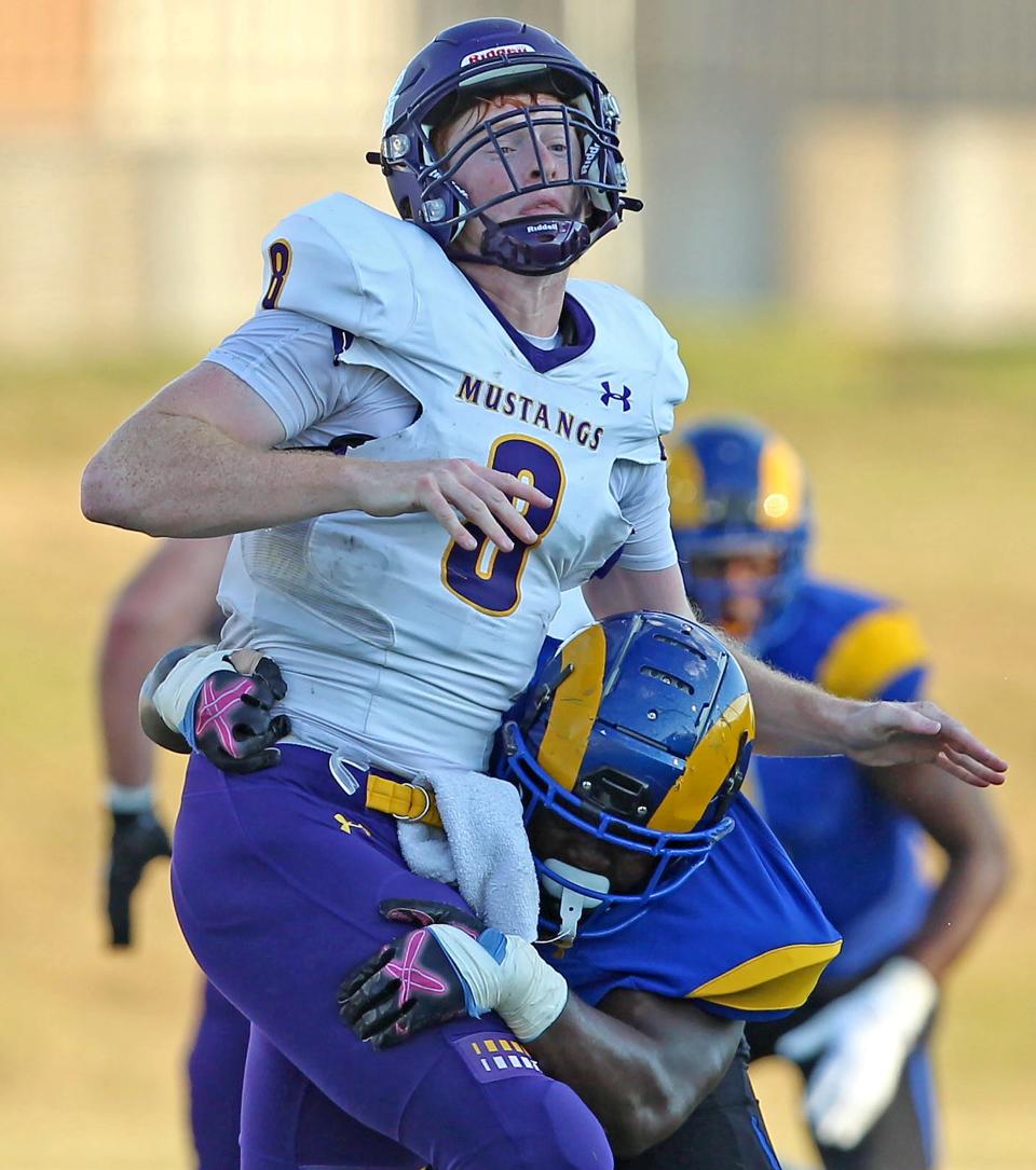 Angelo State University's Tre'Darius Colbert, lower right, puts pressure on the opposing quarterback during a game against Western New Mexico on Saturday, Oct. 2, 2021.