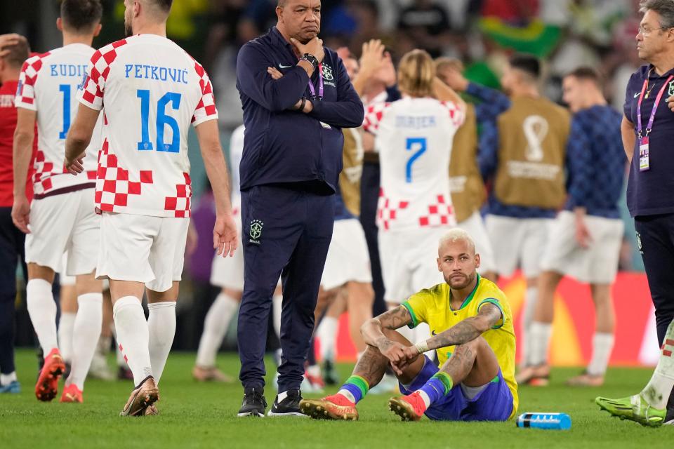 Brazil's Neymar sits on the pitch at the end of the World Cup quarterfinal soccer match between Croatia and Brazil.