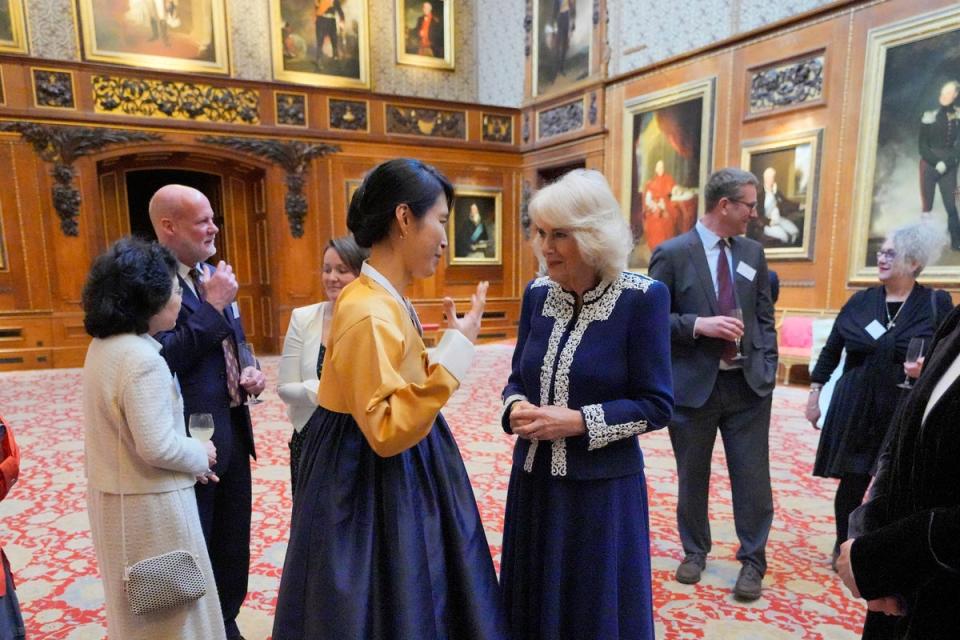 Queen Camilla speaks to Haein Song during a reception at Windsor Castle for authors, illustrators and binders who have been involved in the new Miniature Library collection (Getty Images)