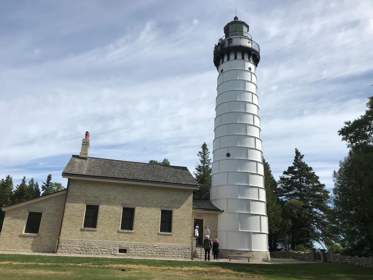 A handful of visitors are at the top of the 89-foot-tall Cana Island Lighthouse in Baileys Harbor. The Door County Maritime Museum opened the tower and light keeper's house, at left, to the public for the first time this season on Aug. 12 after a preservation and restoration project.