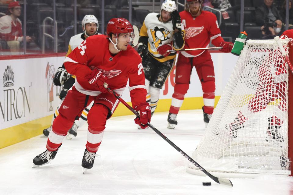 Detroit Red Wings' Pius Suter looks for an open teammate during the first period while playing the Pittsburgh Penguins in a preseason game Thursday, Oct. 7, 2021, in Detroit.