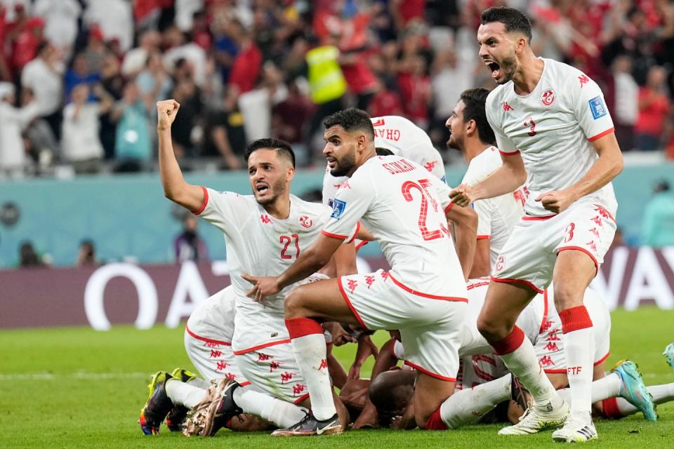 Players of Tunisia celebrate after Wahbi Khazri scored their side's opening goal against France during a World Cup group D football match at the Education City Stadium in Al Rayyan, Qatar, Wednesday, Nov. 30, 2022. (AP Photo/Martin Meissner)