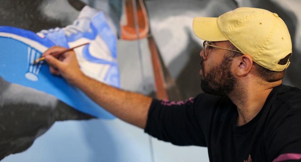 Christian Dixon works on his mural for this year's Fresh Paint: OKC NYE Mural Project at the OKC Farmers Public Market Monday, November 7, 2022.