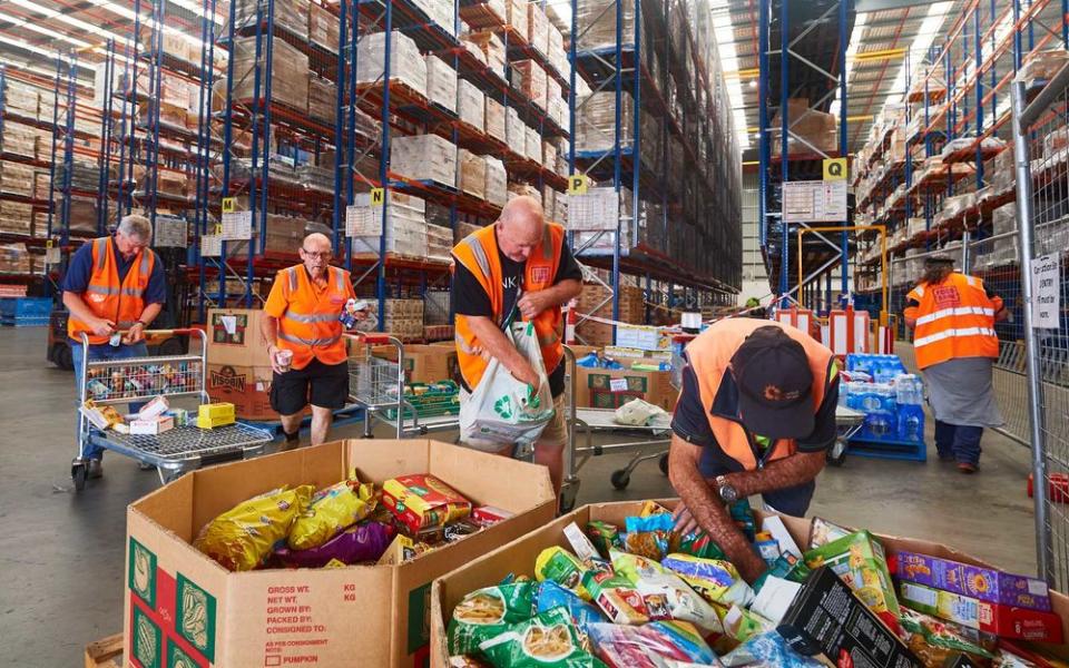 Volunteers help help organise large donations of goods at the Food Bank Distribution Centre bound for areas impacted by bushfires on January 07, 2020 in the Glendenning suburb of Sydney, Australia. | Brett Hemmings/Getty Images