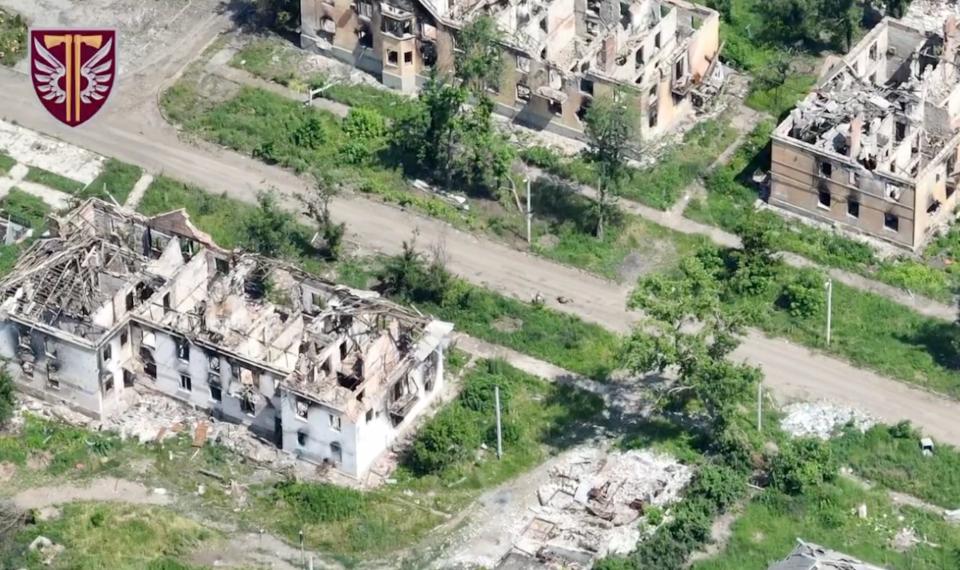 Destroyed buildings in a still from an aerial video