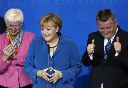 German Chancellor and leader of Christian Democratic Union (CDU) Angela Merkel Gerda Hasselfeldt, head of the faction of Christian Social Union (CSU) in Berlin (L) and CDU party secretary general Hermann Groehe react after first exit polls in the German general election (Bundestagswahl) at the CDU party headquarters in Berlin September 22, 2013. REUTERS/Wolfgang Rattay