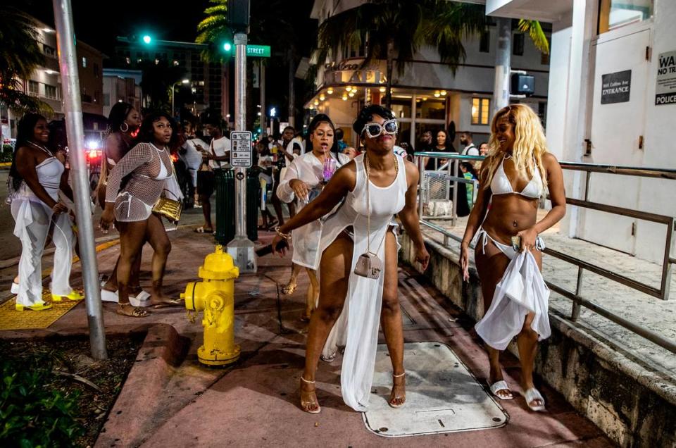 A group of women twerk on Washington Avenue on Saturday, March 26, 2022, an hour before a midnight curfew imposed by the City of Miami Beach for the South Beach area, due to two shootings in Miami Beach the weekend before, that caused city officials to announce a “state of emergency”.