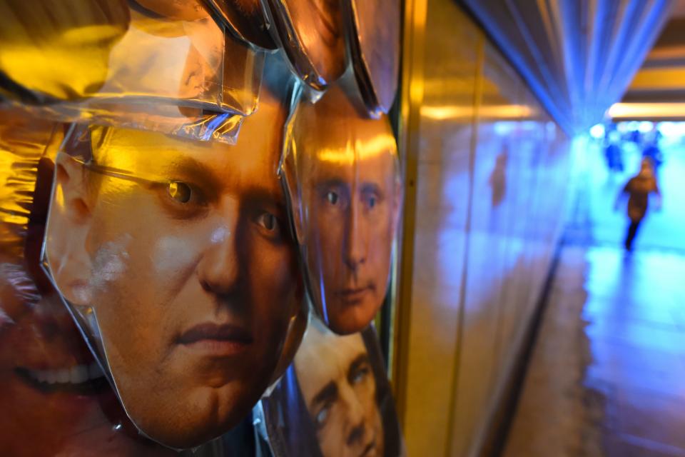 <p>Masks of opposition leader Alexei Navalny and President Vladimir Putin are seen on sale at a souvenir stall in an underground passage in Saint Petersburg </p> (AFP/Getty)