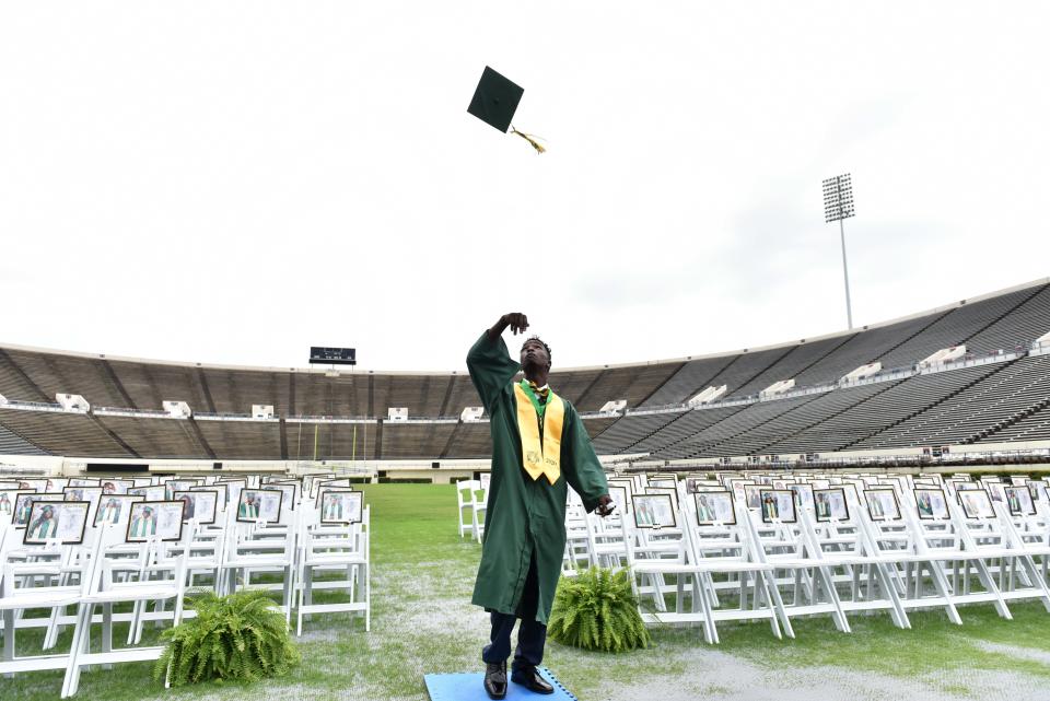 Jim Hill High School student Jonah Johnson tosses his graduation cap after getting his picture taken with his class at the Mississippi Veterans Memorial Stadium in Jackson in 2020.