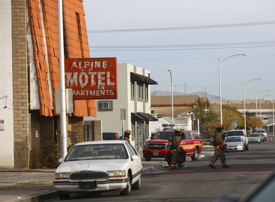 Las Vegas firefighters work the scene of a fire at a three-story apartment complex early Saturday, Dec. 21, 2019 in Las Vegas. The fire was in first-floor unit of the Alpine Motel Apartments and its cause was under investigation, the department said. Authorities say multiple fatalities were reported and several were injured. (Chase Stevens /Las Vegas Review-Journal via AP)