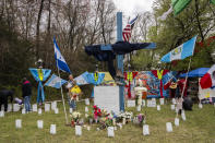 A memorial site to honor the construction workers who lost their lives in the collapse of the Francis Scott Key Bridge sits on the side of the road near the blockade to Fort Armistead Park, in Baltimore, Saturday, April 6, 2024. Roberto Marquez, an artist from Dallas, painted a mural in their honor as well as painted their names on several crosses dotting the perimeter of flowers, candles and other items of remembrance. Members of the community honored the victims through prayer and song. (Kaitlin Newman/The Baltimore Banner via AP)
