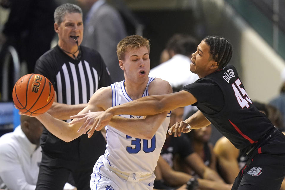 Gonzaga guard Rasir Bolton (45) defends against BYU guard Dallin Hall (30) during the first half of an NCAA college basketball game Thursday, Jan. 12, 2023, in Provo, Utah. (AP Photo/Rick Bowmer)