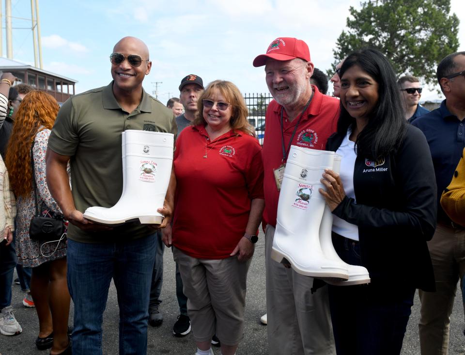 Gov. Wes Moore and Lt. Gov. Aruna Miller are presented with rain boots at the J. Millard Tawes Crab and Clam Bake Wednesday, Sept. 27, 2023, at Somers Cove Marina in Crisfield, Maryland.