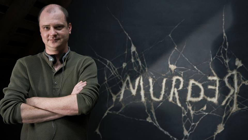 Director Mike Flanagan against the "Murder" chalkboard in Doctor Sleep.