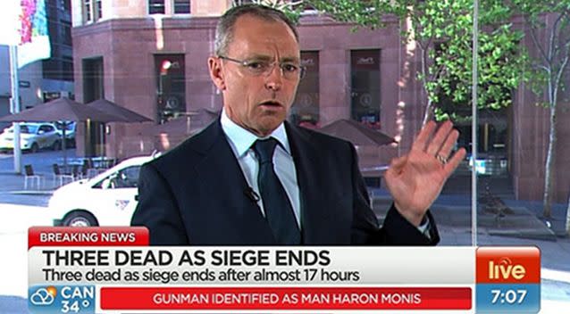 Chris Reason covering the siege. Photo: 7 News