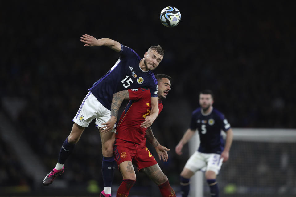 Scotland's Ryan Porteous, top, challenges for the ball with Spain's Joselu during the Euro 2024 group A qualifying soccer match between Scotland and Spain at the Hampden Park stadium in Glasgow, Scotland, Tuesday, March 28, 2023. (AP Photo/Scott Heppell)