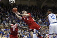 North Carolina State forward Jericole Hellems (4) drives past Duke forward Javin DeLaurier (12) for a shot during the first half of an NCAA college basketball game in Durham, N.C., Monday, March 2, 2020. North Carolina State forward D.J. Funderburk (0) looks on. (AP Photo/Gerry Broome)