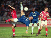 FILE - Chelsea's Gianluca Vialli, center, attempts the overhead kick during an exhibition match against Hong Kong's South China team Tuesday, May 20, 1997 at Hong Kong-s Siu Sai Wan Stadium. Gianluca Vialli, the former Italy striker who helped both Sampdoria and Juventus win Serie A and European trophies before becoming a player-manager at Chelsea, has died on Friday, Jan. 6, 2023. He was 58. (AP Photo/Vincent Yu, file)
