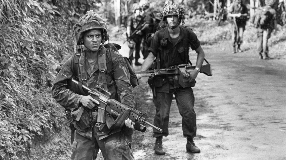 Troops with B Company, 2nd Battalion, 505th Parachute Infantry Regiment patrol in Grenada in November 1983. (The Fayetteville Observer)