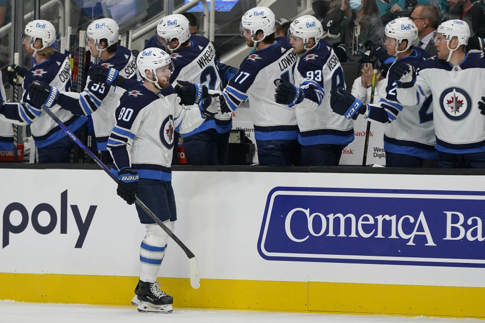 Winnipeg Jets center Pierre-Luc Dubois, foreground, is congratulated by teammates after his goal against the San Jose Sharks during the first period of an NHL hockey game in San Jose, Calif., Saturday, Oct. 16, 2021. (AP Photo/Jeff Chiu)